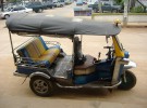 A tuk tuk in front of a guest house