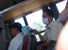 A passenger wearing a mask in the bus