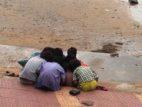 A group of young boys gambling with coins gathered from River Godavari in Rajahmundry, Andhra Pradesh. Don't miss the bunch of magnet rings they use ...