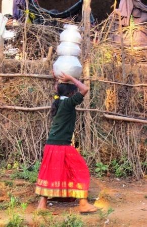 Carrying loads of water from community hand-pump for her house in Dumbriguda, Andhra Pradesh