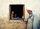 78 year old Sheikh Hassan Khalafala talks with his grandson at their family home in Rashda village.