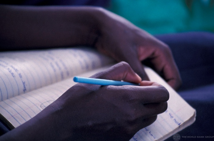 Student writing notes, Kenya